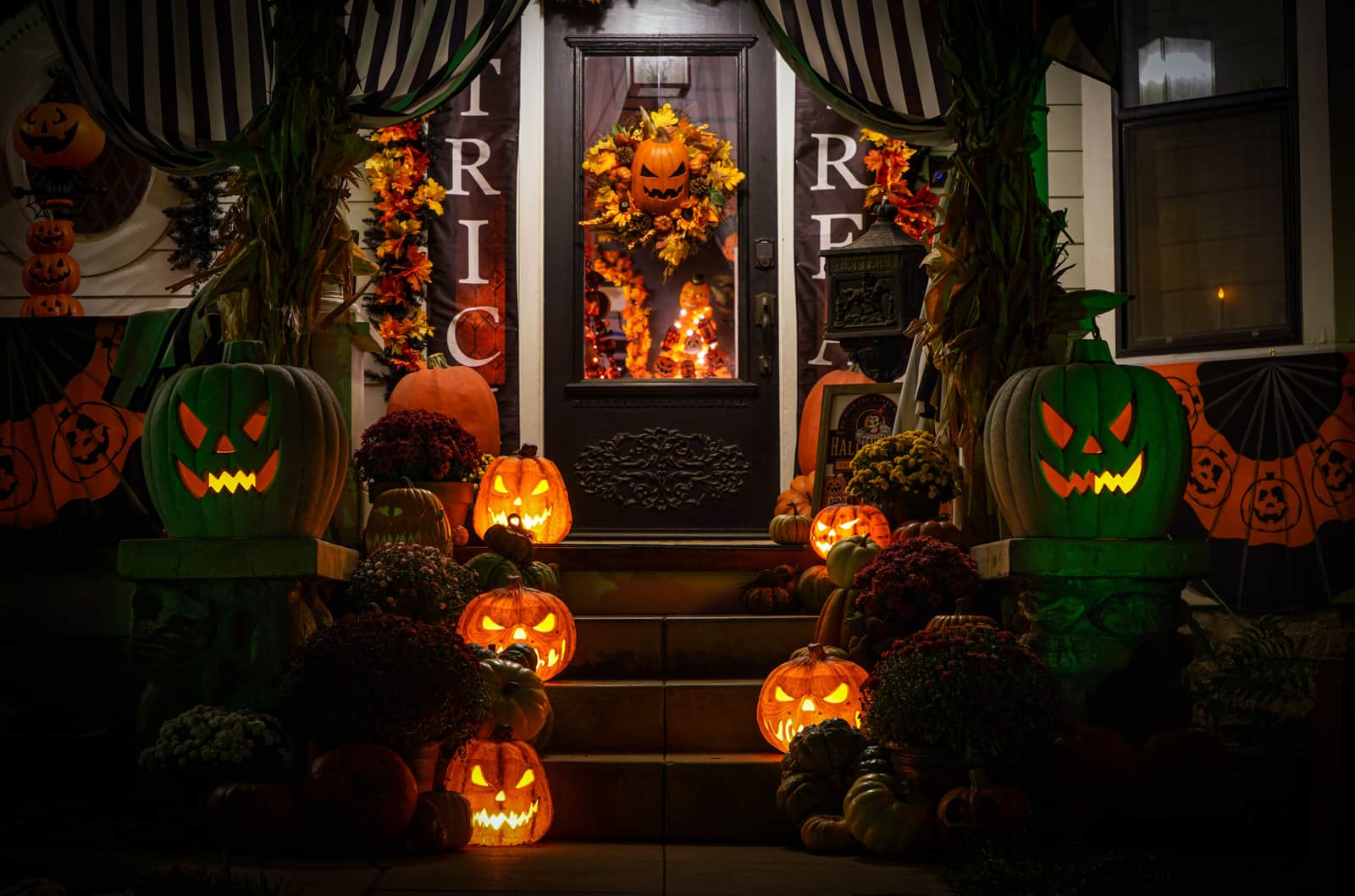Halloween decorations lit outside a house at night